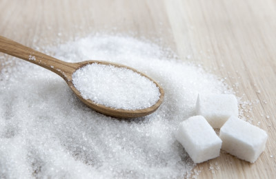 Sugar on wooden table. Selective focus